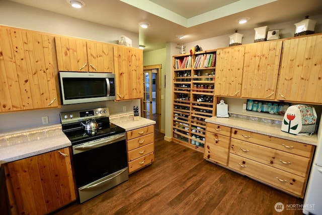kitchen featuring stainless steel appliances, dark wood-style flooring, light brown cabinets, and recessed lighting