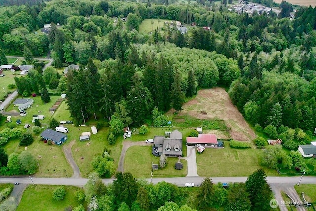 view of property location with a forest