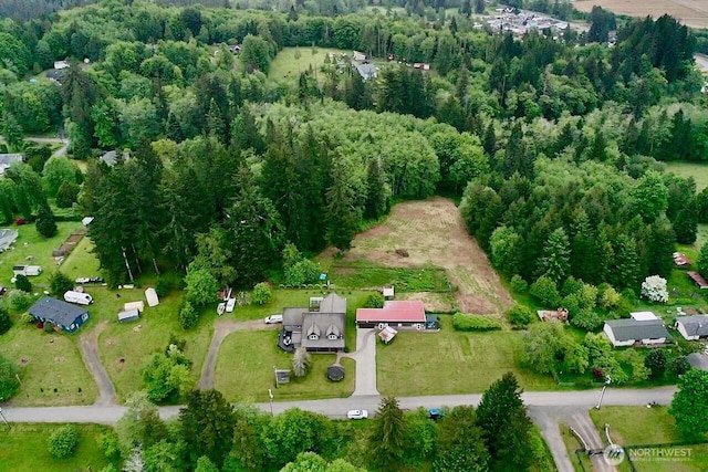 aerial view of property's location with a forest