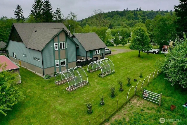 view from above of property featuring a heavily wooded area