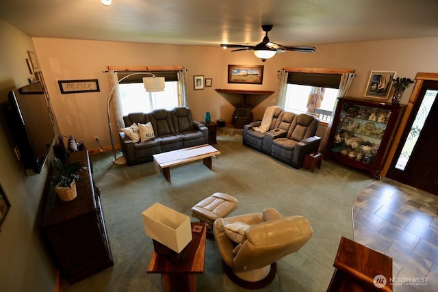living room featuring healthy amount of natural light and a ceiling fan
