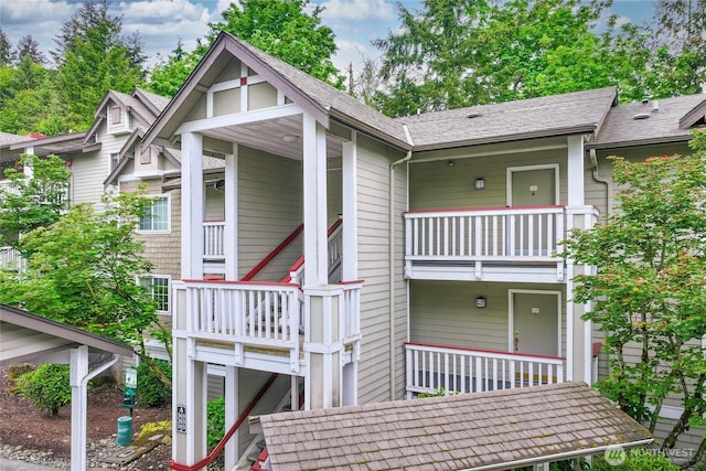 18505 SE Newport Way Unit A203, Issaquah, WA 98027 - view of front of house featuring a balcony and roof with shingles