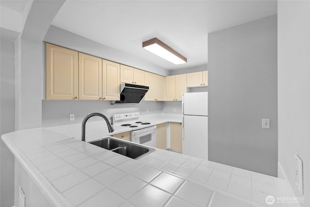 18505 SE Newport Way Unit A203, Issaquah, WA 98027 - kitchen with white appliances, a sink, cream cabinets, tile countertops, and a peninsula