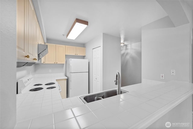 18505 SE Newport Way Unit A203, Issaquah, WA 98027 - kitchen with white appliances, a sink, a peninsula, and light brown cabinets