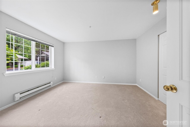 18505 SE Newport Way Unit A203, Issaquah, WA 98027 - empty room with a baseboard heating unit, carpet, and baseboards