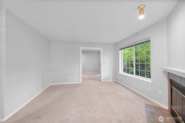 18505 SE Newport Way Unit A203, Issaquah, WA 98027 - unfurnished living room with carpet flooring, baseboards, and a tiled fireplace