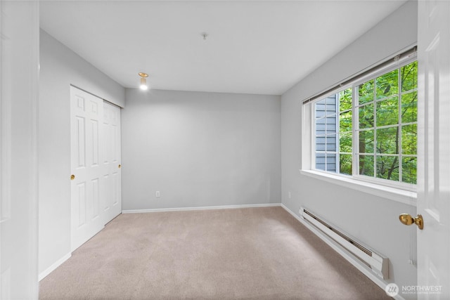 18505 SE Newport Way Unit A203, Issaquah, WA 98027 - unfurnished bedroom with a baseboard radiator, carpet floors, and baseboards