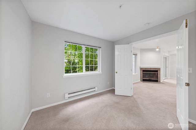 18505 SE Newport Way Unit A203, Issaquah, WA 98027 - unfurnished living room featuring a baseboard heating unit, carpet floors, baseboards, and a fireplace
