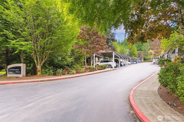 18505 SE Newport Way Unit A203, Issaquah, WA 98027 - view of asphalt road with curbs and sidewalks