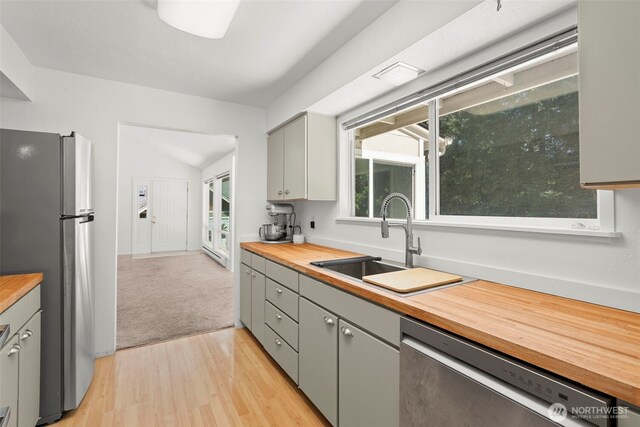 270 Puget Loop, Port Ludlow, WA 98365 - kitchen with wood counters, stainless steel appliances, gray cabinetry, and light wood-type flooring