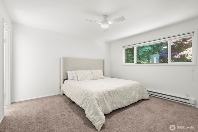 270 Puget Loop, Port Ludlow, WA 98365 - bedroom featuring baseboard heating, carpet floors, and a ceiling fan