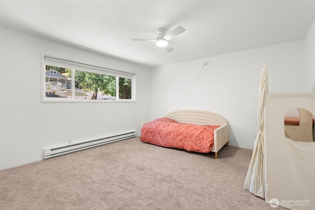 270 Puget Loop, Port Ludlow, WA 98365 - carpeted bedroom with baseboard heating and a ceiling fan