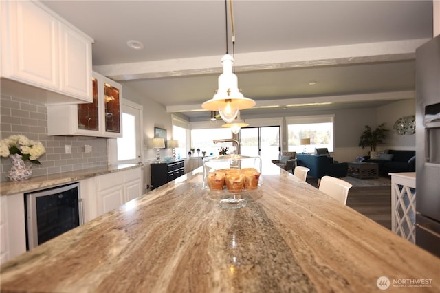 5341 S Bercot Rd, Freeland, WA 98249 - dining room featuring beverage cooler, beam ceiling, healthy amount of natural light, and wood finished floors