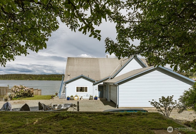 5341 S Bercot Rd, Freeland, WA 98249 - back of house featuring a water view, a patio, a yard, and roof with shingles
