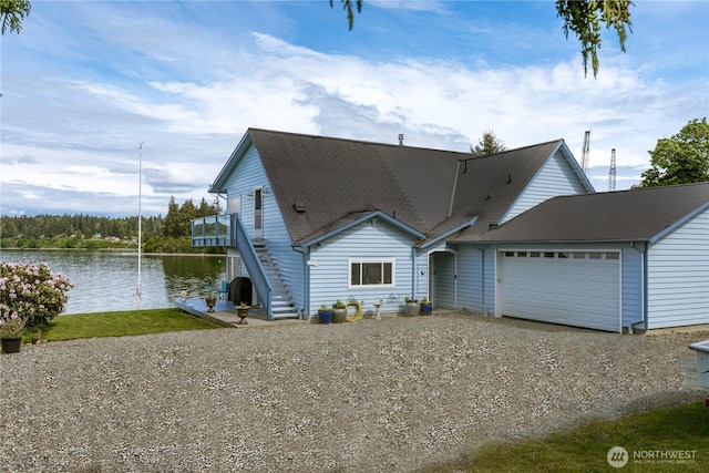 5341 S Bercot Rd, Freeland, WA 98249 - a-frame style home with driveway, an attached garage, stairs, and a water view