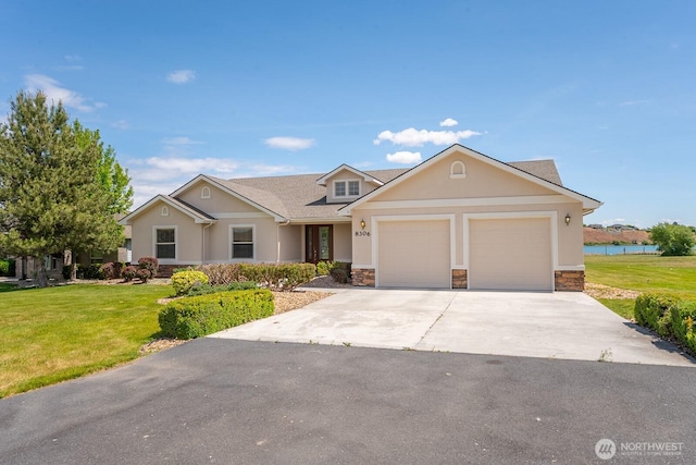 8306ROAD 3.2 NE, Moses Lake, WA 98837 - view of front of property featuring stone siding, an attached garage, a front yard, and driveway