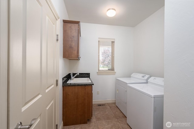 8306ROAD 3.2 NE, Moses Lake, WA 98837 - washroom featuring washer and clothes dryer, cabinet space, light tile patterned floors, and baseboards