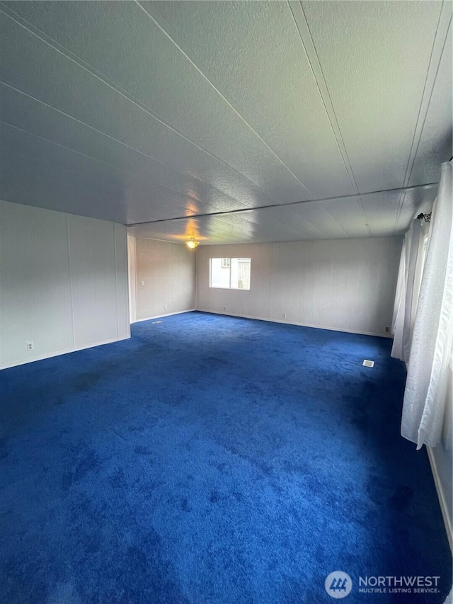 1050 Howard St Unit 10, Raymond, WA 98577 - empty room with a textured ceiling and dark colored carpet