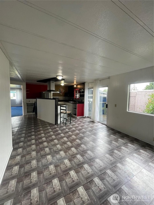 1050 Howard St Unit 10, Raymond, WA 98577 - kitchen with plenty of natural light, dark countertops, a breakfast bar, ventilation hood, and a textured ceiling