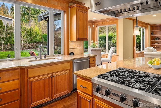 kitchen featuring stovetop with downdraft, a sink, range hood, stainless steel dishwasher, and light stone counters
