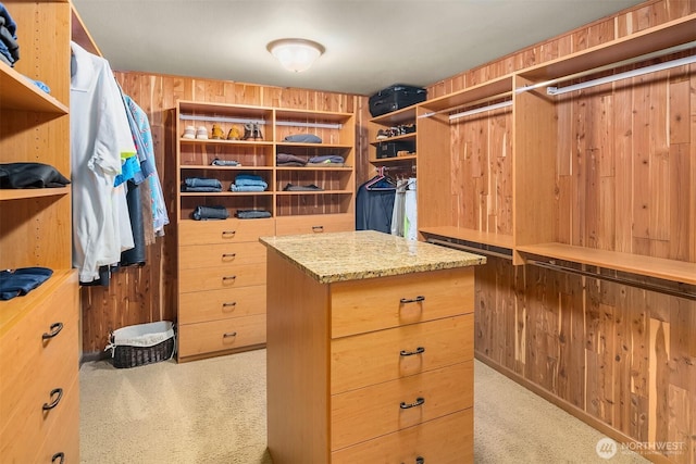 walk in closet with carpet floors
