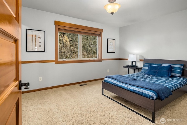 carpeted bedroom with baseboards