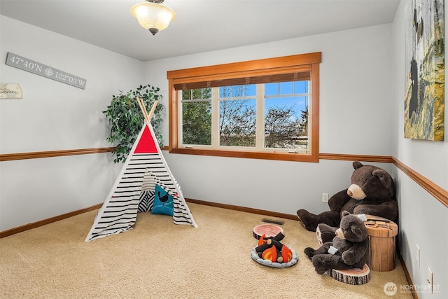 rec room with carpet and baseboards