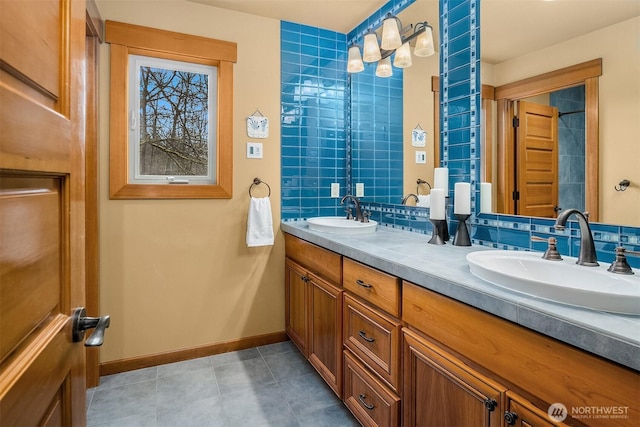 bathroom featuring double vanity, baseboards, and tile patterned floors