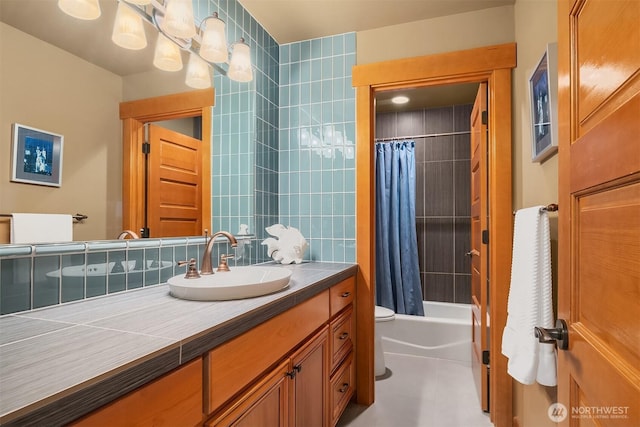 full bath featuring vanity, shower / tub combo, and toilet