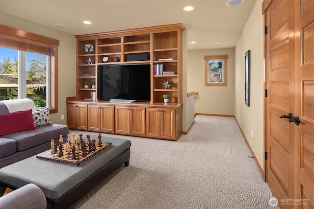 living area with recessed lighting, baseboards, and light colored carpet
