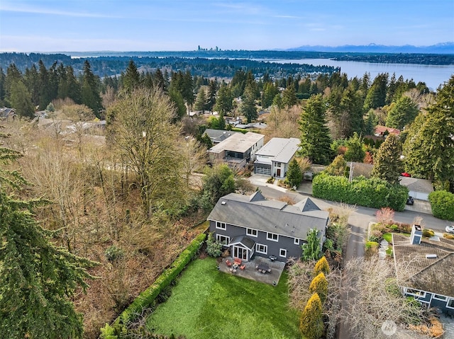 bird's eye view of a nearby body of water and a heavily wooded area