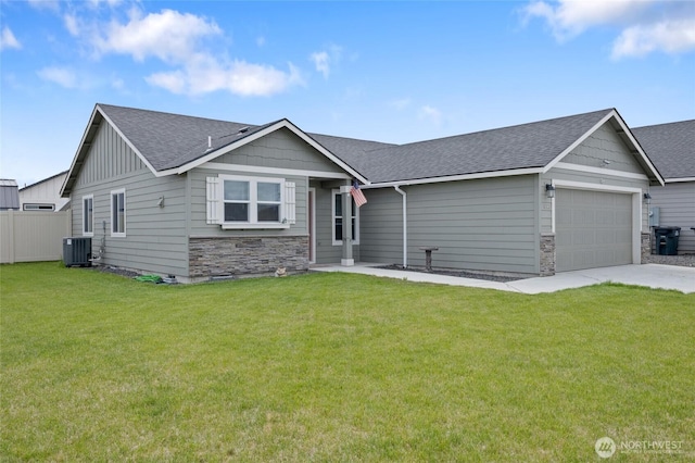 1003 NE Aspen Rd, Moses Lake, WA 98837 - craftsman inspired home featuring central air condition unit, a shingled roof, a garage, and driveway