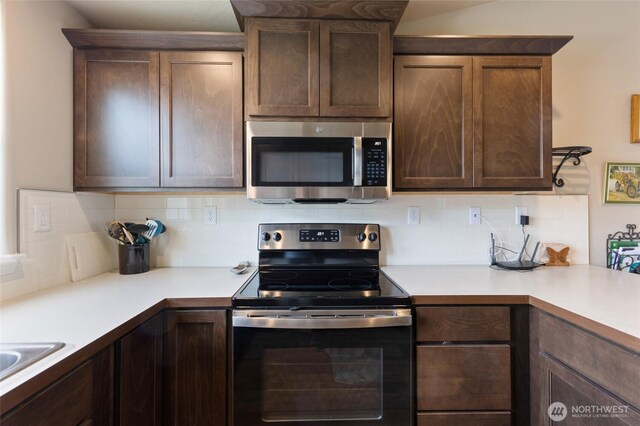 1003 NE Aspen Rd, Moses Lake, WA 98837 - kitchen featuring appliances with stainless steel finishes, backsplash, and light countertops
