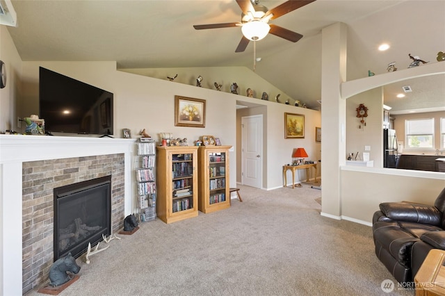 1003 NE Aspen Rd, Moses Lake, WA 98837 - living room with lofted ceiling, a brick fireplace, ceiling fan, carpet, and baseboards