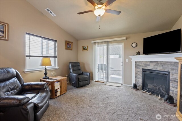 1003 NE Aspen Rd, Moses Lake, WA 98837 - living area with lofted ceiling, healthy amount of natural light, carpet flooring, a ceiling fan, and a brick fireplace
