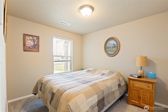 1003 NE Aspen Rd, Moses Lake, WA 98837 - bedroom with light colored carpet and baseboards
