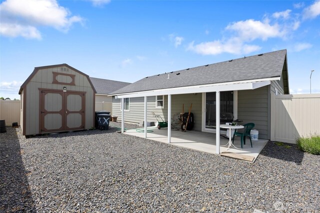 1003 NE Aspen Rd, Moses Lake, WA 98837 - rear view of house with a shed, roof with shingles, a patio, and fence