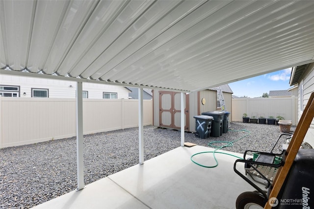 1003 NE Aspen Rd, Moses Lake, WA 98837 - view of patio / terrace with a shed, a fenced backyard, and an outbuilding