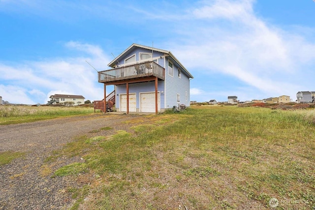 1488 Ocean Shores Blvd SW, Ocean Shores, WA 98569 - view of outbuilding featuring driveway, a garage, and stairs
