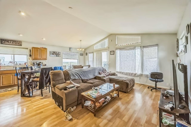 1488 Ocean Shores Blvd SW, Ocean Shores, WA 98569 - living area with a chandelier, vaulted ceiling, and light wood-style floors
