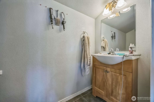 1488 Ocean Shores Blvd SW, Ocean Shores, WA 98569 - bathroom with tile patterned flooring, vanity, a textured wall, and vaulted ceiling