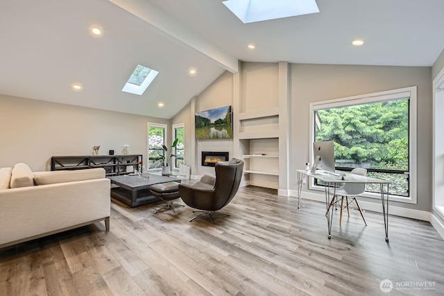 14323 SE 49th St, Bellevue, WA 98006 - living room featuring a skylight, a glass covered fireplace, wood finished floors, recessed lighting, and baseboards