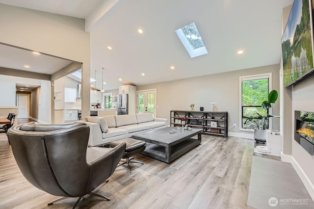 14323 SE 49th St, Bellevue, WA 98006 - living area with light wood finished floors, baseboards, a skylight, vaulted ceiling, and recessed lighting