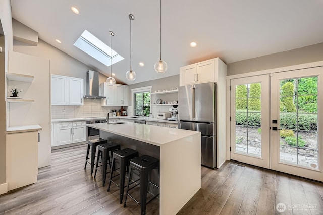 14323 SE 49th St, Bellevue, WA 98006 - kitchen featuring open shelves, stainless steel appliances, wall chimney range hood, a skylight, and a sink