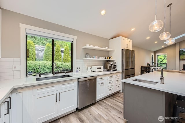 14323 SE 49th St, Bellevue, WA 98006 - kitchen with stainless steel appliances, a sink, light wood-style flooring, backsplash, and recessed lighting