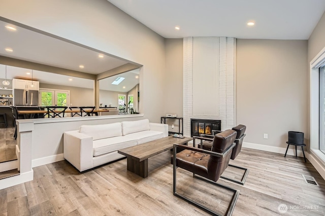 14323 SE 49th St, Bellevue, WA 98006 - living room with light wood-style flooring, a fireplace, recessed lighting, and baseboards
