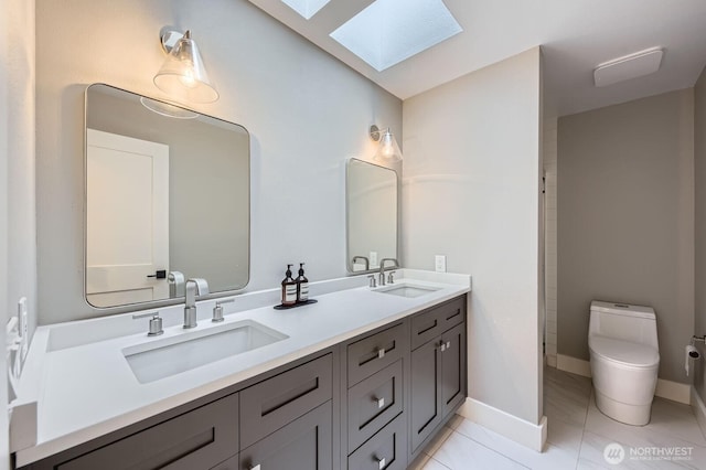 14323 SE 49th St, Bellevue, WA 98006 - full bathroom featuring a skylight, toilet, double vanity, and baseboards