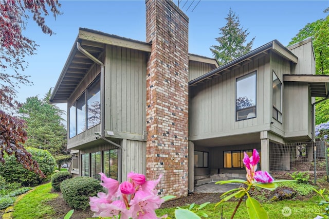 14323 SE 49th St, Bellevue, WA 98006 - rear view of property with a chimney