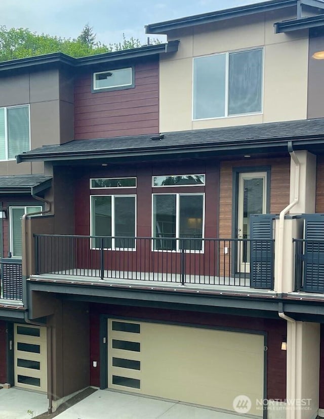 13214 NE 127th Ct Unit D, Kirkland, WA 98034 - view of front of house featuring a garage, a balcony, and central AC