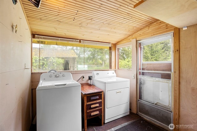 washroom with washing machine and clothes dryer and wood ceiling